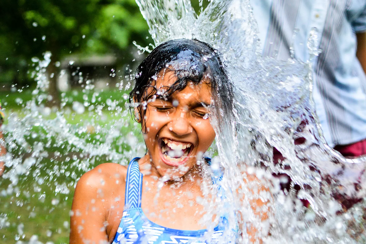 Camper getting water dumped on them while smiling