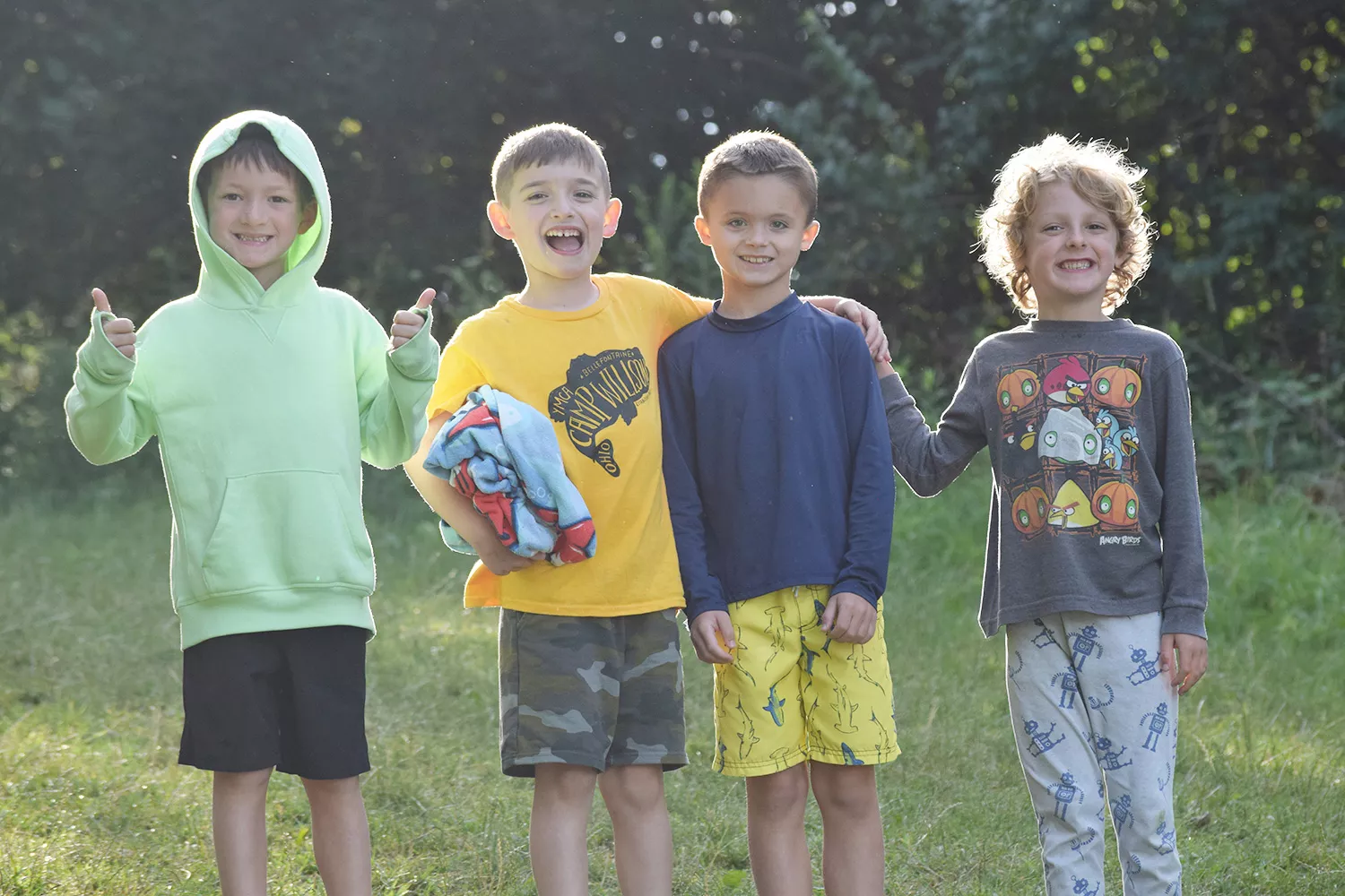 Four campers smiling outside together
